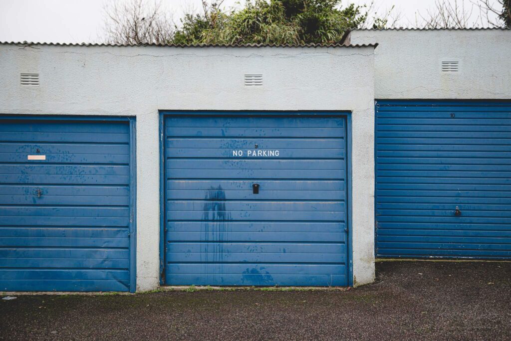 No parking sign on a blue garage door